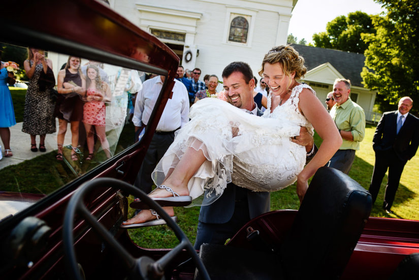 Lincoln united church wedding;Lincoln vermont wedding;Vermont wedding photographers;groom lifting bride
